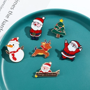 Set of 6 Christmas enamel pins featuring Santa, reindeer, and snowman on a green plate