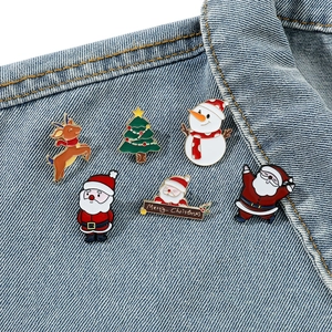 6-piece set of cute Christmas enamel pins including Santa and reindeer on denim jacket