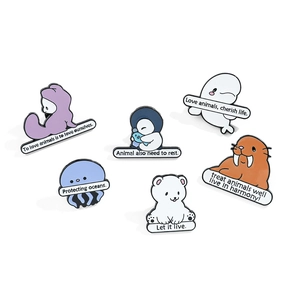 Cartoon ocean animal enamel pin set featuring dolphin, seal and polar bear motifs