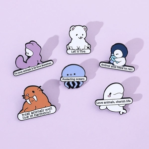 Flat lay of six cute cartoon marine animal enamel pins with sea protection slogans
