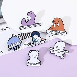 Detailed view of metal enamel pins featuring marine animals and eco-friendly slogans