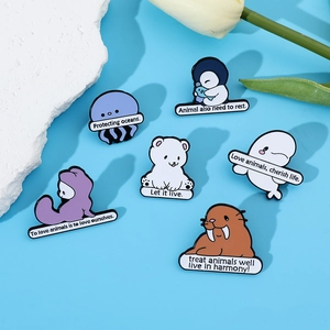 Detailed view of six cartoon marine animal enamel pins with eco-friendly slogans