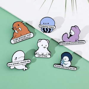 Close-up of cartoon ocean animal enamel pins with environmental protection slogans