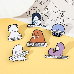 Detail of marine life enamel pins featuring polar bears, penguins and ocean slogans