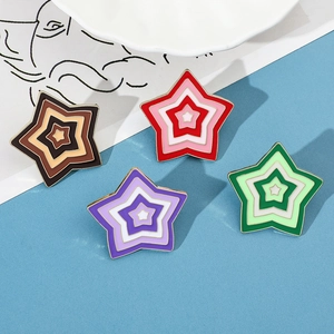 Detailed view of four colorful enamel star pins with gradient layers and gold metal edges