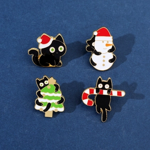 Detailed set of four Christmas black cat enamel pins featuring holiday themes and gold metal