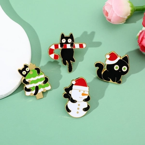 Detailed view of four Christmas black cat enamel pins with festive holiday motifs
