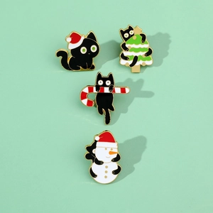 Detailed close-up of four festive enamel pins featuring black cats with Christmas elements