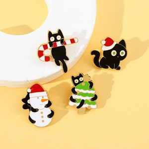 Detail of four festive Christmas cat enamel pins with colorful alloy holiday patterns