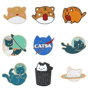 Enamel lapel pin set featuring cute cartoon tigers and space-themed cats on white background