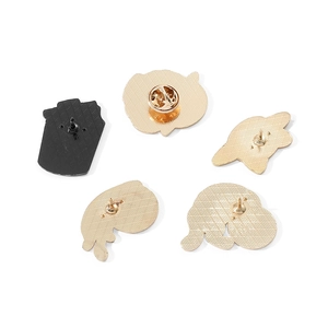 Macro view of five enamel pin backs showing butterfly clutch and textured metal base