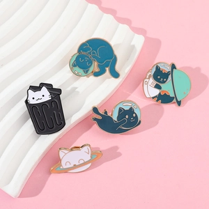 Detailed view of 5 cute enamel cat pins featuring space and astronaut themes on pink background