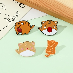 Detailed set of four cute cartoon tiger enamel pins in various playful poses