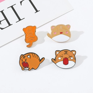 Set of four cute cartoon tiger enamel pins in orange and white for backpack decoration