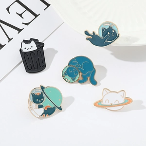Detailed view of 5 cute enamel space cat pins with polished metal finish on white backdrop