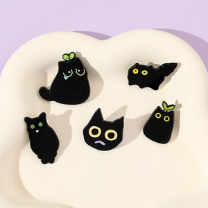 Set of 5 cute black cat enamel pins featuring unique cartoon shapes and green plant details