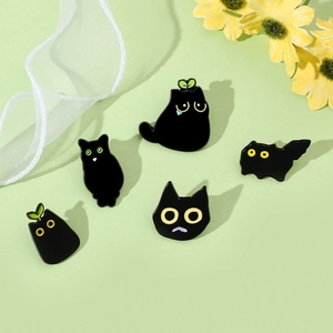 Detailed view of five cute black cat enamel pins with different cartoon expressions