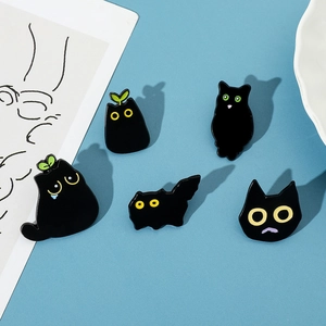 Detailed collection of black cartoon cat enamel pins in various cute poses on blue surface
