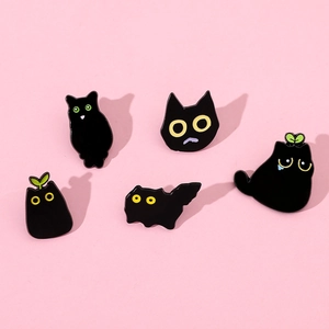 Set of five cartoon black cat enamel pins featuring unique cute feline designs on pink base