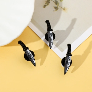 Macro detail of three dagger enamel pins with feminist slogans on yellow background