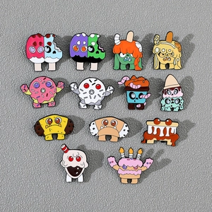 Detailed set of 11 colorful enamel monster pins in donut and cupcake designs