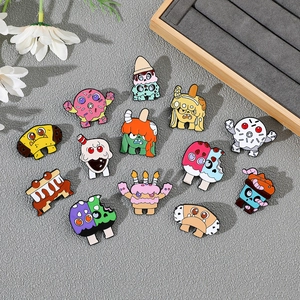 Detailed close-up of cute cartoon donut monster enamel pins on a wooden display tray