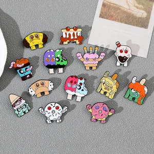 Close-up of 12 cartoon monster enamel pins featuring donut and ice cream designs