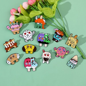 Detailed close-up of colorful cartoon monster dessert enamel pins set in various shapes