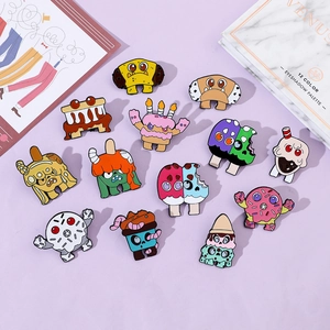 Macro shot of 14 cartoon monster donut and ice cream enamel pins on purple background