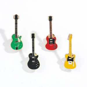 Set of four colorful guitar-shaped metal badges in green, black, red, and yellow colors