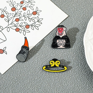 Close-up of Sun Wukong enamel pins including golden headband and decorative horn