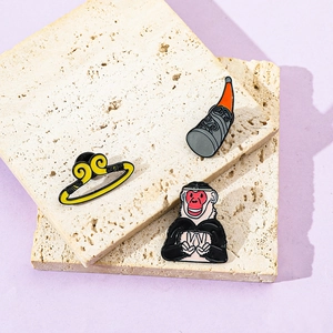 Detailed enamel pins set featuring cartoon Sun Wukong and golden hoop on stone