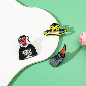 Macro detail of Sun Wukong enamel pins featuring the golden headband and magic gourd