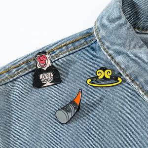 Cartoon Monkey King enamel pin set on denim jacket featuring Sun Wukong and golden hoop