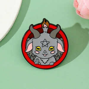 Macro shot of cartoon devil goat enamel pin with pentagram symbol on red metal circle