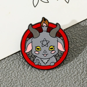 Close-up of cartoon Baphomet enamel pin with red circle and pentagram detail