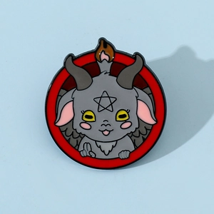 Macro shot of cartoon Baphomet enamel pin with goat horns and pentagram symbol