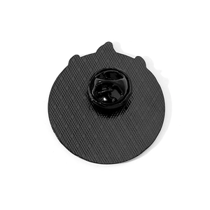 Detailed back view of the black metal badge showing anti-slip texture and rubber clutch