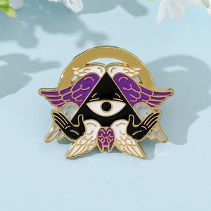 Macro view of Cthulhu angel enamel pin with golden wings and mystical eye detail