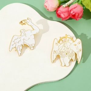 Close-up of white enamel seraphim pins with golden edges on a heart-shaped stand