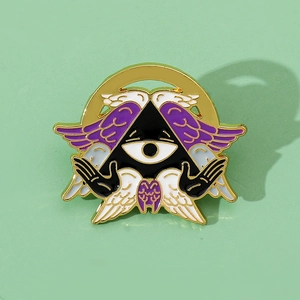 Enamel Cthulhu angel eye lapel pin with purple wings and golden metal base detail