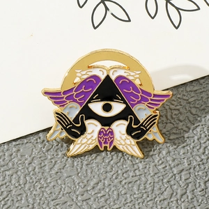 Detailed close-up of Cthulhu Angel enamel pin with purple wings and mystic eye symbol