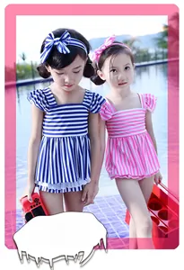 Close-up of navy and pink striped girl's swimsuit with lace hem and matching headbands