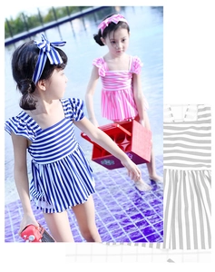 Detail of navy stripe two-piece girls swimsuit with ruffled sleeves and matching headband