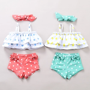 Detail of ruffle bikini sets with polka dots and bow headbands in coral and mint green