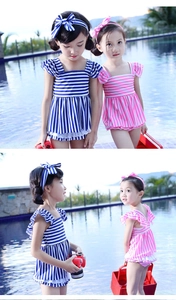 Detail of navy and pink striped girls' swimwear with ruffle sleeves and lace hem