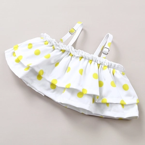 Detail of baby girl ruffle swim top with yellow polka dots and adjustable metal buckle
