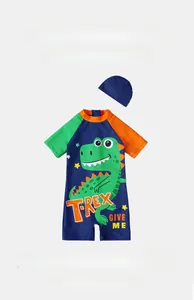 Detail of navy blue kids dinosaur swimsuit set with short sleeves and matching cap