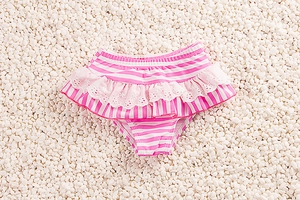 Detail of pink and white striped swim bottom with ruffle skirt and white lace embroidery