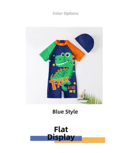Detail of blue kids one-piece swimsuit featuring green dinosaur print and matching cap
